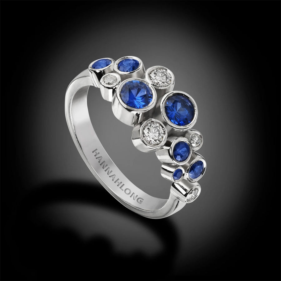 diamond and sapphire cluster ring in platinum with bezel settings