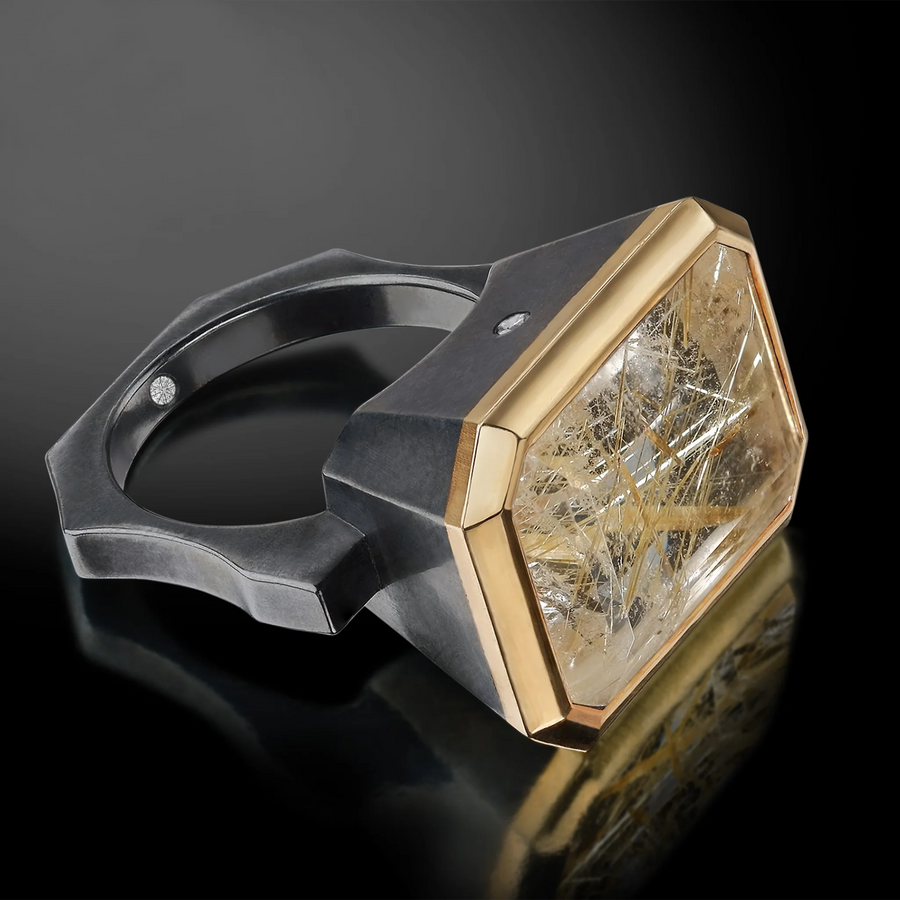 large rutilated emerald cut quartz ring in blackened sterling silver with 18Karat yellow gold bezel rim setting and two small accent diamonds